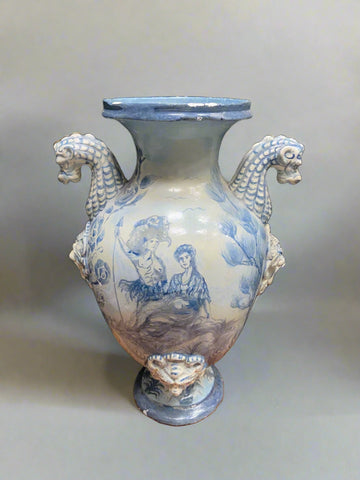Grecian style blue and white ceramic vase with seahorse-shaped handles.