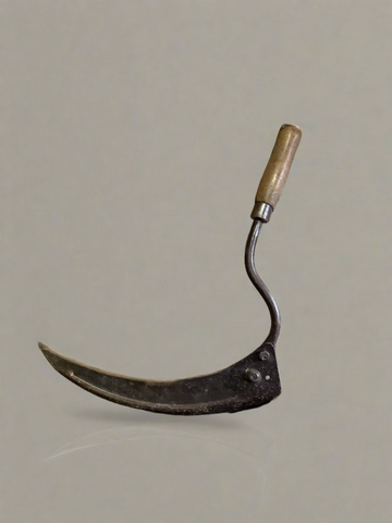 Antique short-handled scythe with a wooden grip handle.