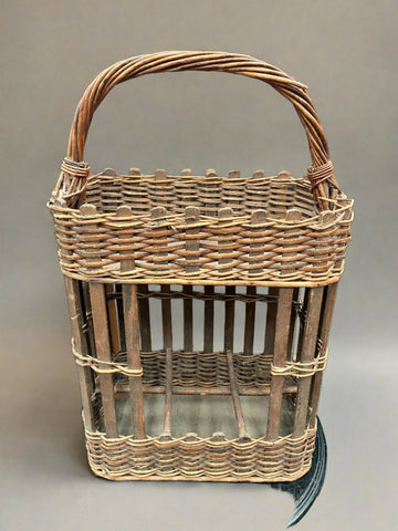 Vintage two-tier French basket designed for carrying wine bottles.