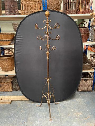Vintage Hollywood gold metal coat rack with a large acorn-shaped finial. 