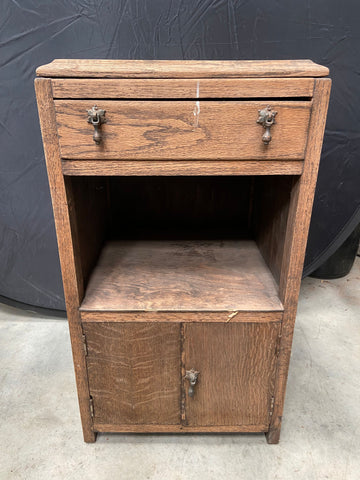 Wooden standing side cabinet with hanging metal handles.