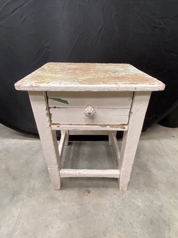 Vintage white bedside table with a charming country farmhouse style.