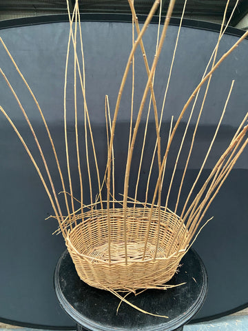 Unfinished oval wicker planter.