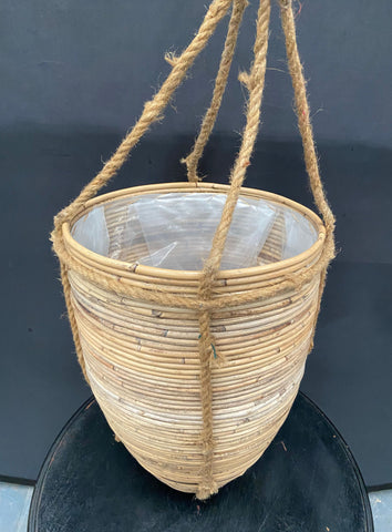 Ribbed rattan hanging planter in the shape of a beehive.&nbsp;