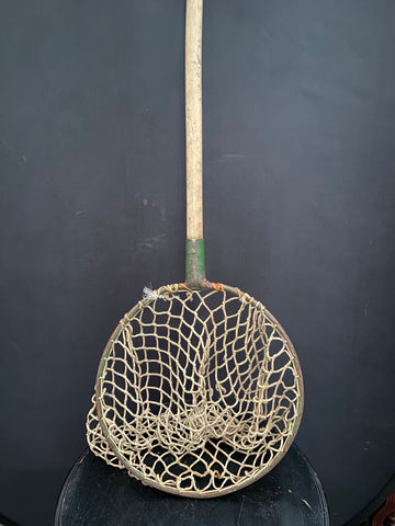 Antique angler's landing net with an open thick rope weave.