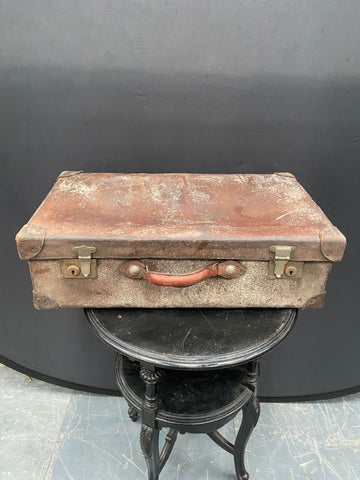 Very aged vintage brown leather suitcase.