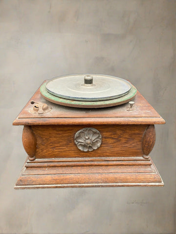 An early 20th-century wooden gramophone player with a stone rose detail.