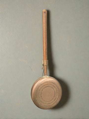 Large muted copper bed warming pan with a plain wooden handle.