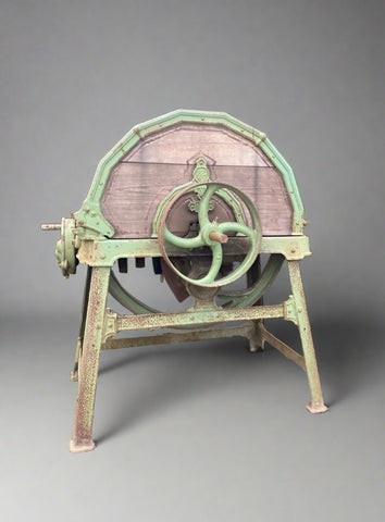 Antique green metal and wooden wheat chaff cutter.