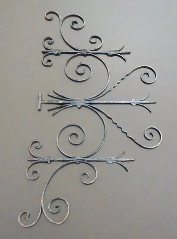 Large ornate symmetrical wrought iron bracket, with some light aging.