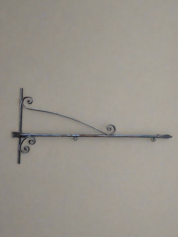 Long wrought iron bracket for sign hanging with an arrowhead end.