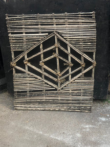 Unusual diamond detailed fence panel constructed from cane and rope.