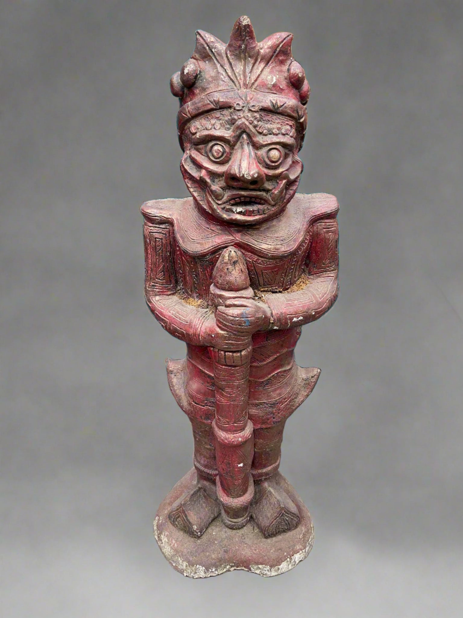 Large Tiki style hand-carved statue, holding a staff.