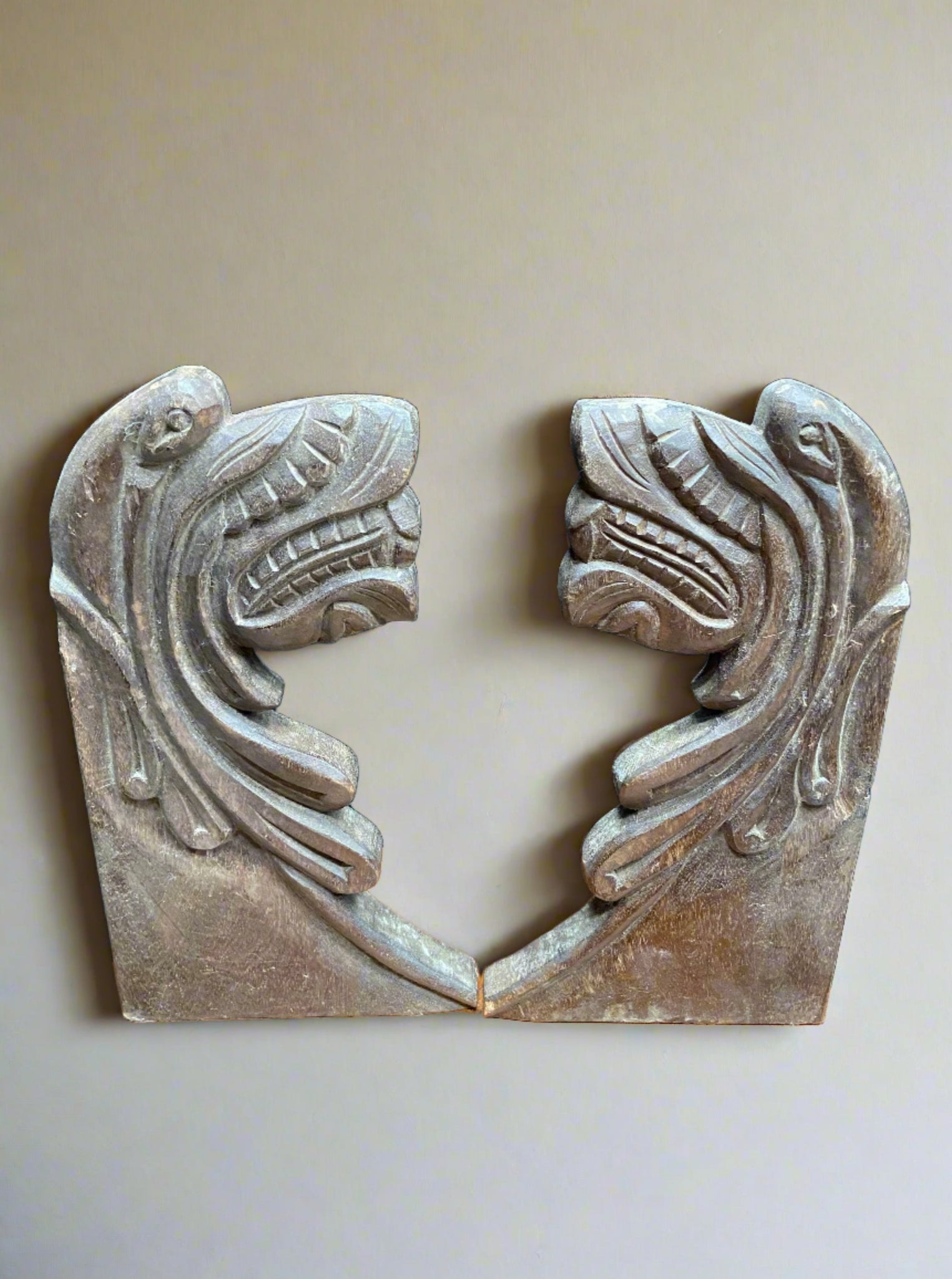 Matching pair of ornate carved wall hangings/ bookends.