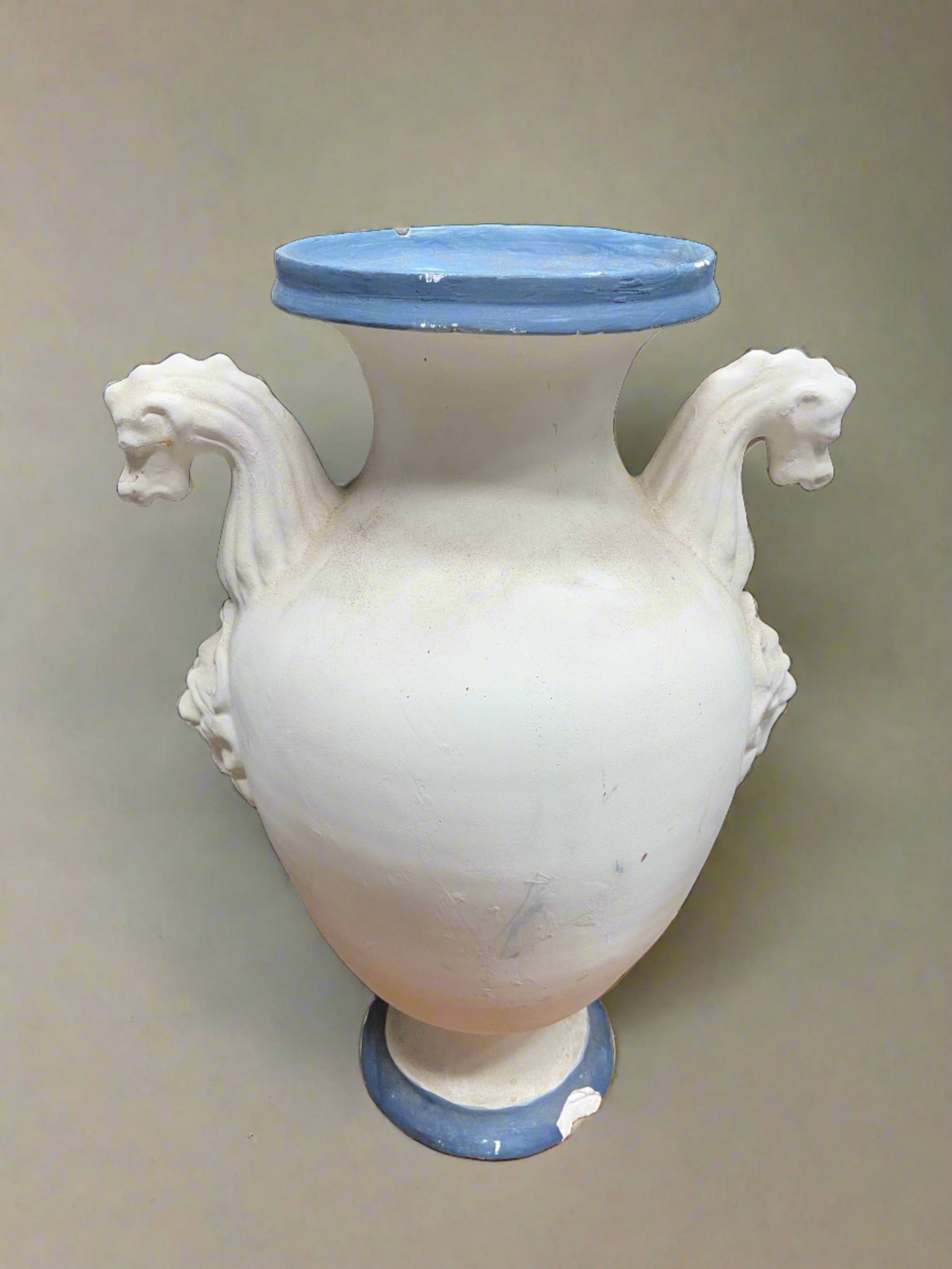 Grecian style blue and white decorative ceramic vase with seahorse-shaped handles.