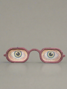 Large propmake signage of eyes wearing red glasses.