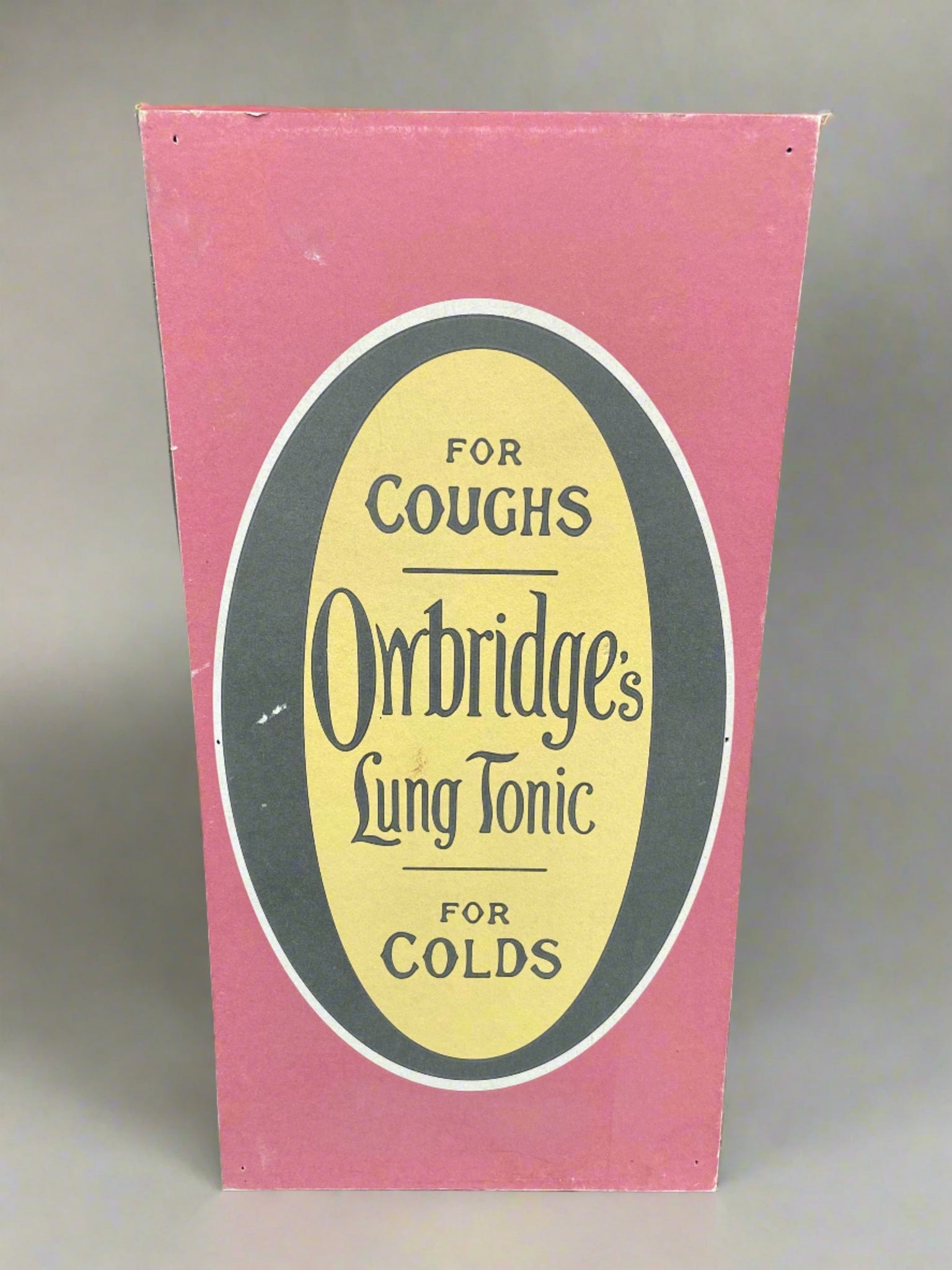 Owbridge's Lung Tonic sign- for coughs- for colds. Printed on a thick card backboard.  This is a prop make but Owbridge's was a real company from the Victorian period. The Owbridge's Lung Tonic was invented in 1874 by pharmacist Walter Owbridge and it was supposedly a cough syrup to remedy bronchitis asthma and consumption (tuberculosis.)