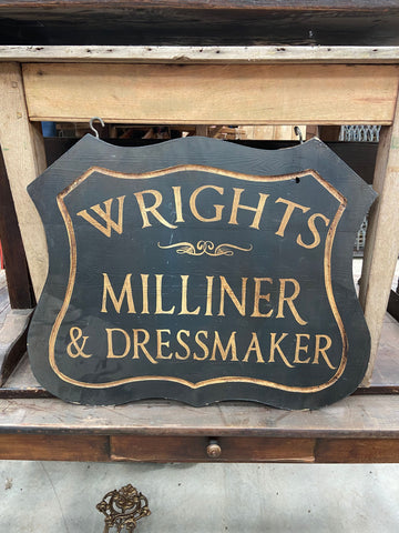'Wrights Milliner & Dressmaker' sign, stenciled onto a cut wooden backboard Film TV Props