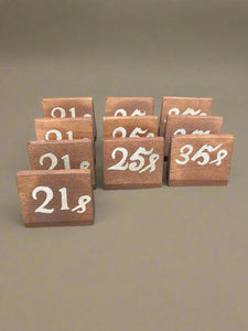 Antique price signs hand painted on wooden blocks.