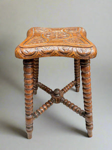 Arts & Crafts carved wooden stool/ plant table. It features a central carved rosette and bobbin legs in a Victorian style.