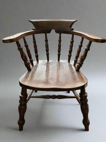 A Victorian elm and beech smoker's bow elbow chair- with eight-turned spindles and a varnished finish. Perfect dressing for a period study or library.