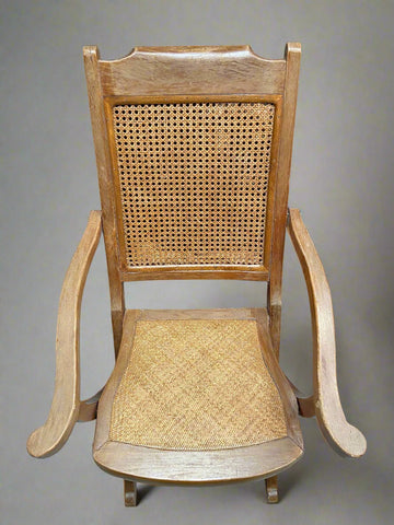 Wooden folding chair with a cane rattan back and woven cane seat.