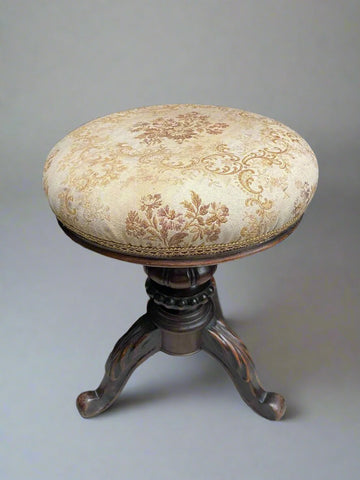 Victorian walnut piano stool upholstered in traditional floral fabric.