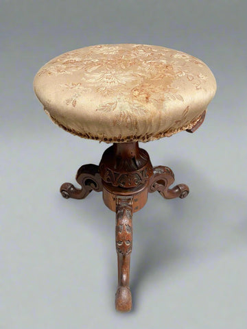 Victorian carved wooden piano stool with silk floral fabric upholstery.