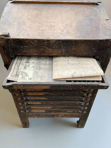 Antique wooden printer's drawers with sectioned drawers for printing type blocks.