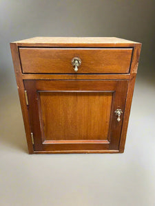 Wooden kitchen cabinet with silver drop handles.