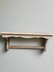 Simple wooden shelf with curved edging.