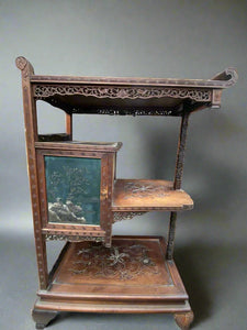 Intricate oriental wooden display stand with numerous painted and carved details.