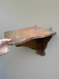 A pair of small wooden shelves with curved edging.