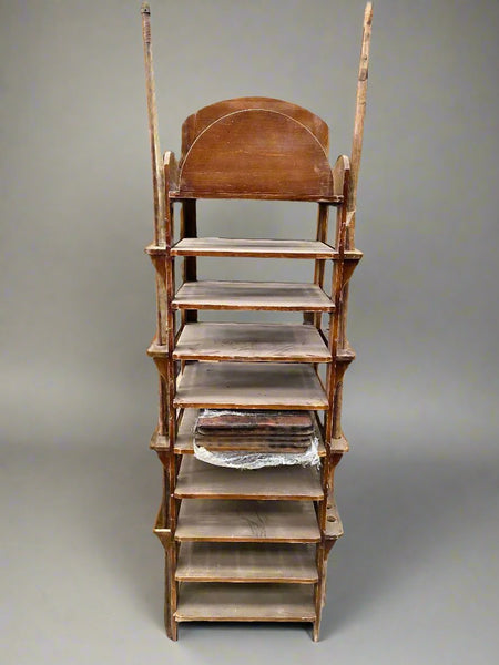 Antique wooden baking rack with two oven shovels that slide into side holders.