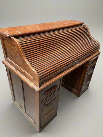 Tambour fronted roll top bureau with six drawers.