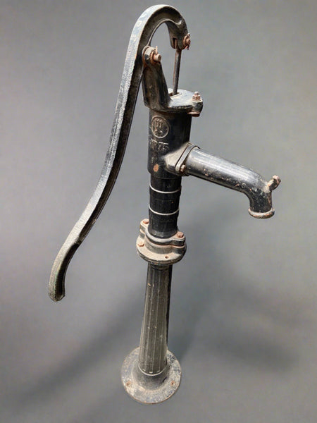 Antique cast iron hand water pump, which would have once been found in the street.