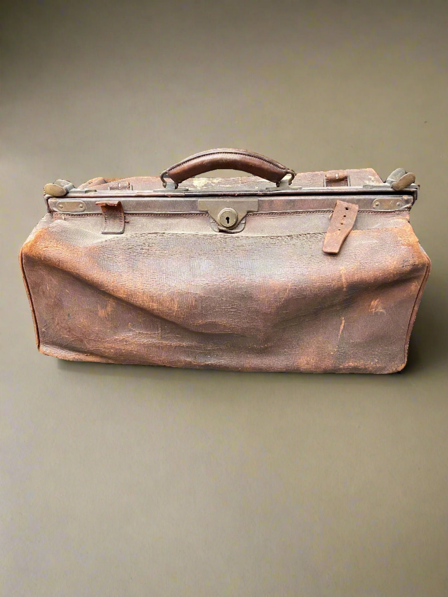 Slouched brown leather doctor's bag in a vintage style.