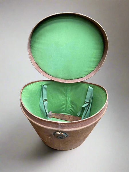 Brown fabric hat box with a bright green fabric lining.