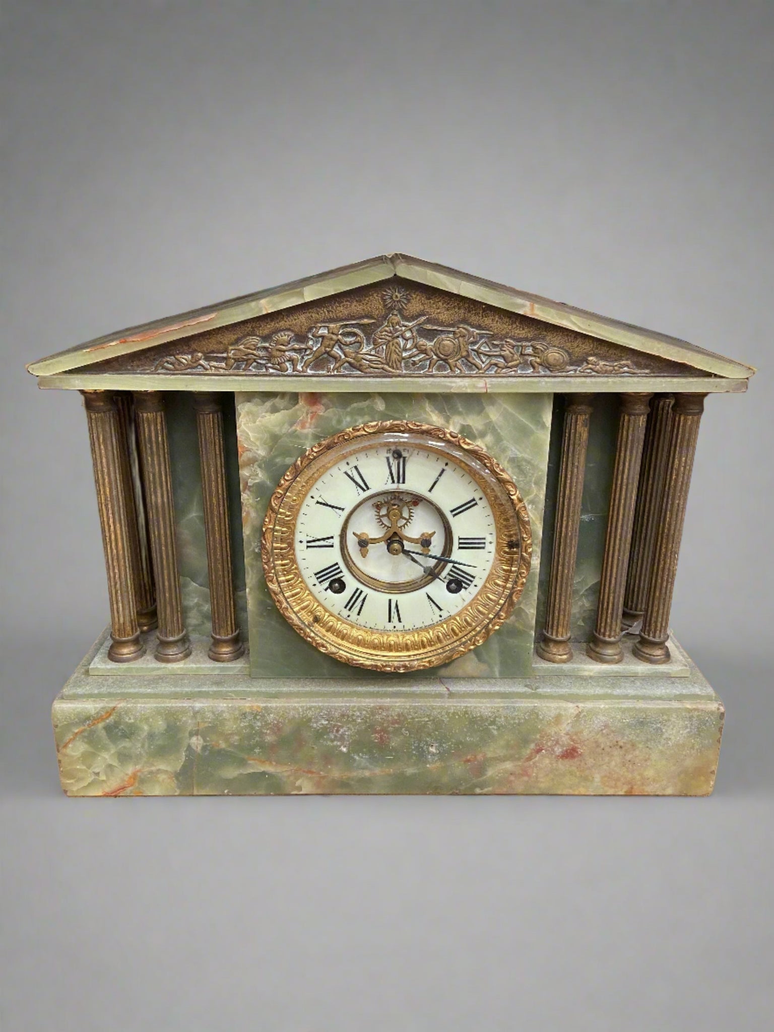 Victorian green onyx and brass mantel clock, circa late 19th century. A classical Grecian temple design with a pediment set upon brass columns.