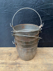 A Stack of Small Metal Buckets