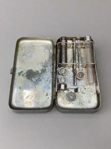 Silver metal medical tin filled with miscellaneous tools.