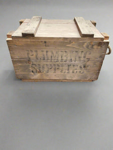 Rustic wooden crate stamped in black ink with 'Plumbing Supplies' Ashwood Film TV Props London