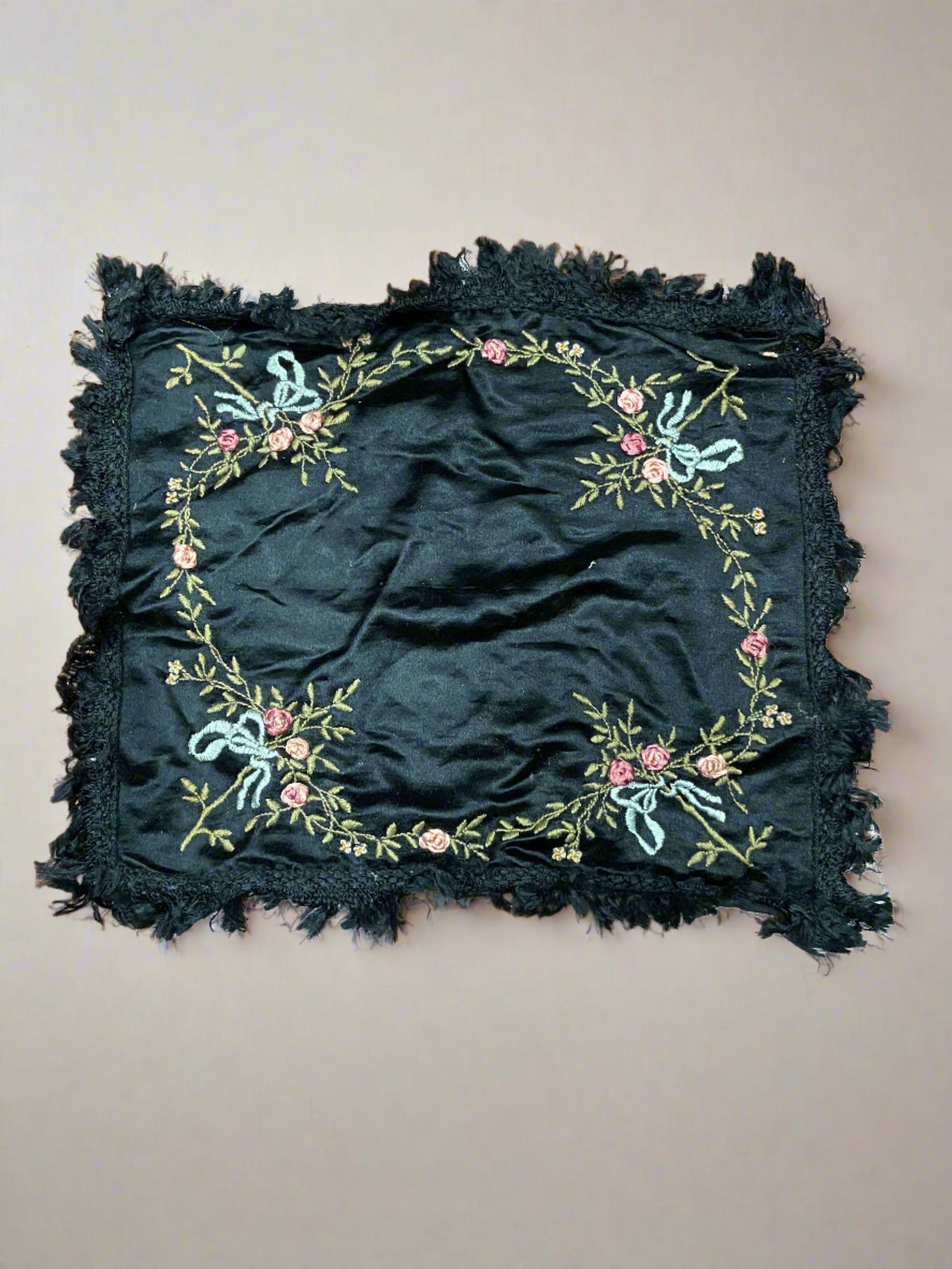 Black silk mourning handkerchief embroidered with pink and blue floral patterns.