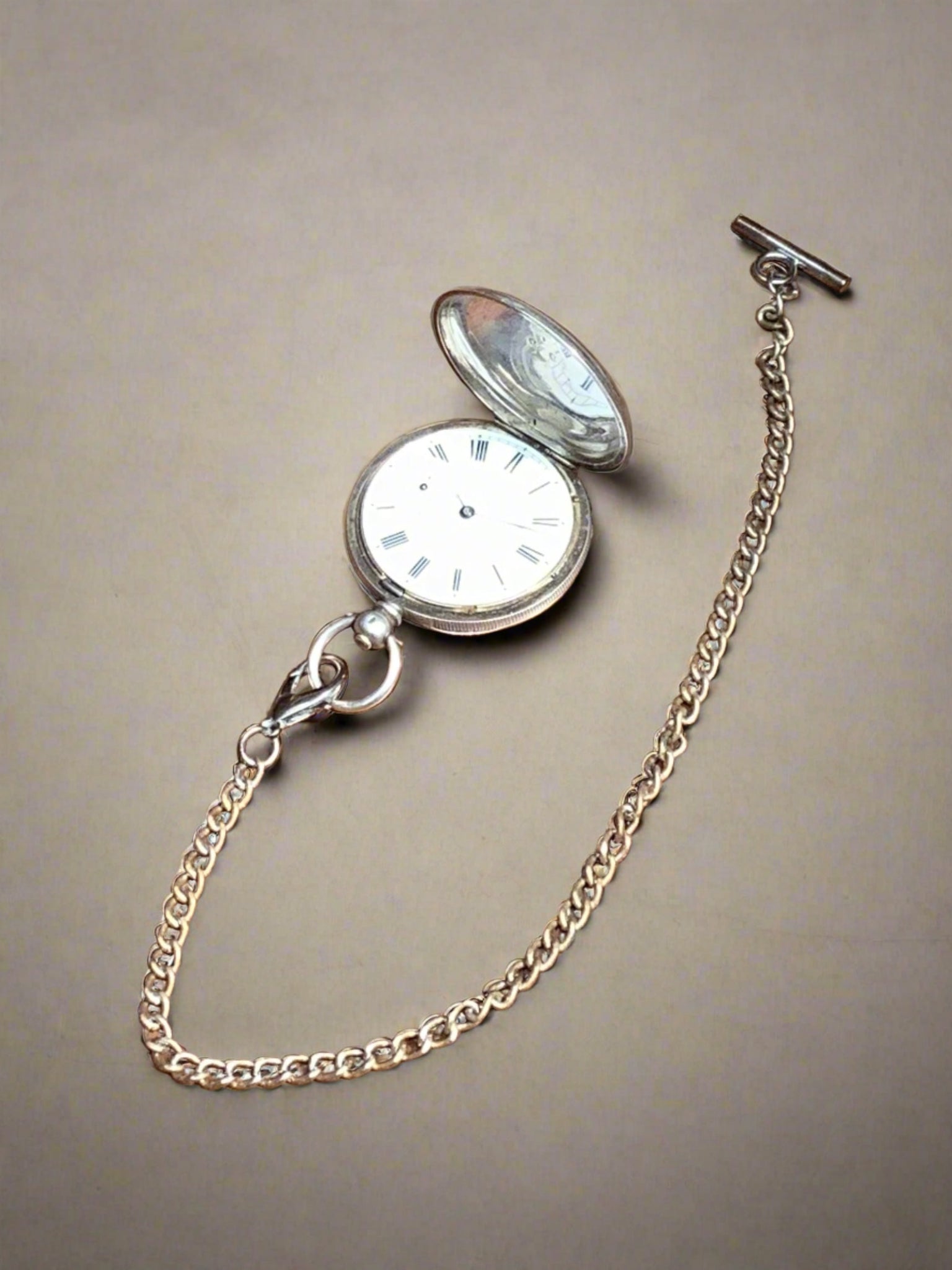 Vintage classic silver pocket watch on a long silver chain.