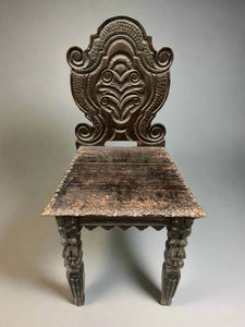 A set of hand-carved ebonised hallway chairs.