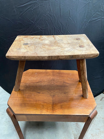 Rustic three-legged milking stool. 