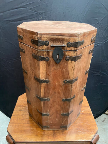 Octagonal medieval-style tall wooden chest with a hinged lid and metal bracing. 