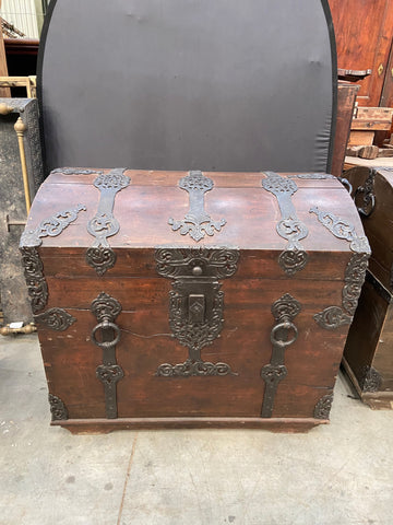A pair of large solid oak treasure chests with domed tops and decorative iron strapwork. Circa 1800s; could also be a sea captain's chest.