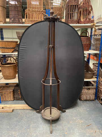 Large Edwardian wooden hat and coat stand with a central drip tray for holding umbrellas.