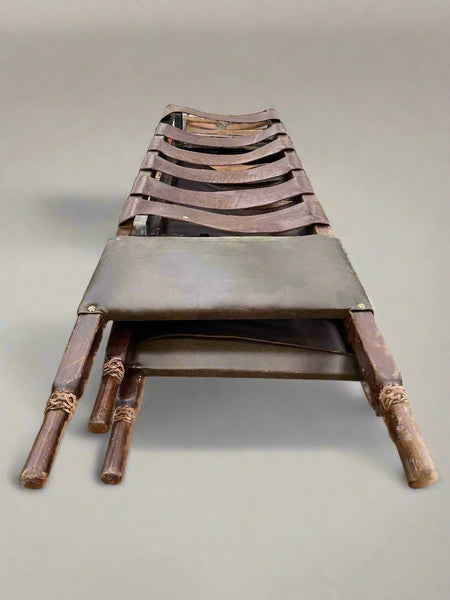 A set of medieval-style leather medical stretchers.